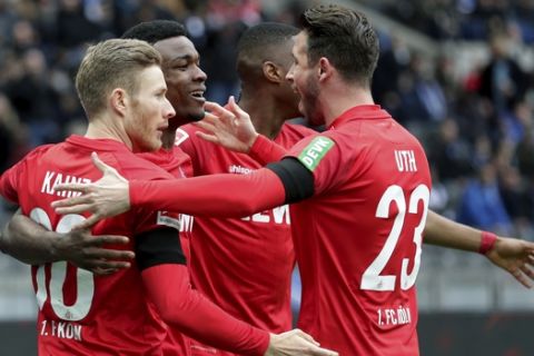 Cologne's scorer Jhon Cordoba, second left, and his teammates celebrate the opening goal during the German Bundesliga soccer match between Hertha BSC Berlin and 1.FC Cologne in Berlin, Germany, Saturday, Feb. 22, 2020. (AP Photo/Michael Sohn)