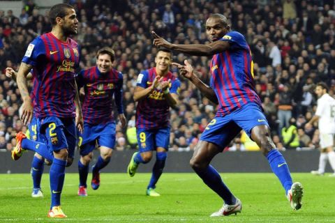 Barcelona's French defender Eric Abidal (R) celebrates after scoring during the Spanish Cup "El clasico" football match Real Madrid vs Barcelona at the Santiago Barnabeu stadium in Madrid on January 18, 2012.   Barcelona won 1-2. TOPSHOTS AFP PHOTO / BJORN S.JOHNSON (Photo credit should read BJORN S.JOHNSON/AFP/Getty Images)