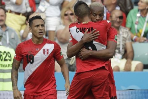 Peru's Andre Carrillo, right, celebrates with Peru's Yoshimar Yotun, left and Peru's Christian Cueva, after scoring his side's opening goal during the group C match between Australia and Peru, at the 2018 soccer World Cup in the Fisht Stadium in Sochi, Russia, Tuesday, June 26, 2018. (AP Photo/Gregorio Borgia)