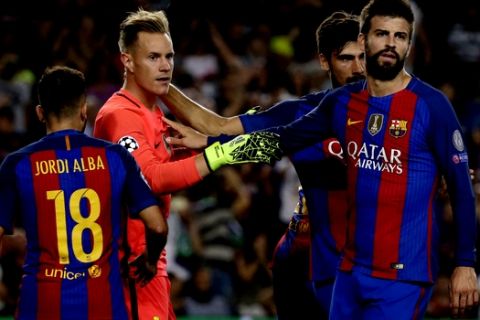 Barcelona goalkeeper Marc-Andre ter Stegen, center is congratulated by team mates fate he saved a penalty kick from Celtic's Moussa Dembele during a Champions League, Group C soccer match between Barcelona and Celtic, at the Camp Nou stadium in Barcelona, Spain, Tuesday, Sept. 13, 2016. (AP Photo/Emilio Morenatti)