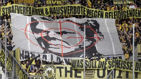 FILE --In this Saturday, Sept. 22, 2018 photo Dortmund fans show a banner with the face of Hoffenheim's sponsor Dietmar Hopp behind a target sign during a German Bundesliga soccer match between TSG 1899 Hoffenheim and Borussia Dortmund in Sinsheim, Germany. (AP Photo/Michael Probst, file)