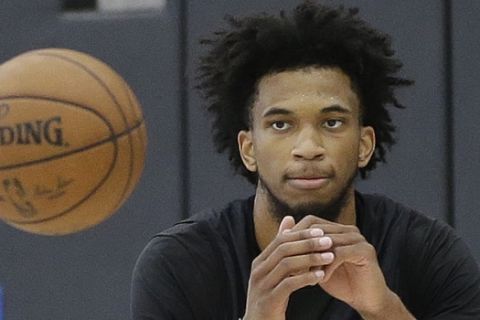 Forward Marvin Bagley III, keeps his eye on the ball during a basketball workout with the Sacramento Kings Monday, June 11, 2018, in Sacramento, Calif. The Kings have the second pick in the upcoming NBA draft and the former Duke star is considered one of the top choices in the draft. (AP Photo/Rich Pedroncelli)