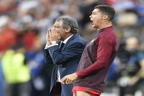 Portugal's Cristiano Ronaldo and Portugal coach Fernando Santos shout instructions from the sidelines during the Euro 2016 final soccer match between Portugal and France at the Stade de France in Saint-Denis, north of Paris, Sunday, July 10, 2016. (AP Photo/Martin Meissner)
