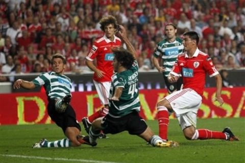 Benfica's Oscar Cardozo, right, from Paraguay, follows his shot scoring the opening goal against Sporting during their Portuguese league soccer match Sunday, Sept. 19 2010, at Benfica's Luz stadium in Lisbon. (AP Photo/Armando Franca)