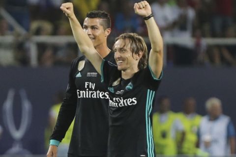 Real Madrid's players Cristiano Ronaldo, left and Lucas Modric celebrate their win against Manchester United during the UEFA Super Cup final soccer match between Real Madrid and Manchester United at Philip II Arena in Skopje, Tuesday, Aug. 8, 2017. (AP Photo/Boris Grdanoski)