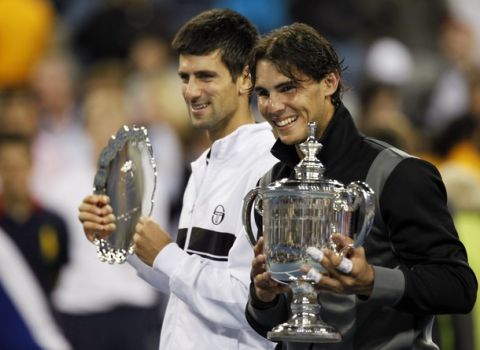 Rafael Nadal (R) of Spain and Novak Djokovic of Serbia pose with their trophies after Nadal won the men's final at the U.S. Open tennis tournament in New York, September 13, 2010.     REUTERS/Gary Hershorn (UNITED STATES  - Tags: SPORT TENNIS)