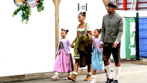 Jerome Boateng, right, player of the German first division, Bundeliga, soccer team FC Bayern Munich, his fiancee Sherin Senler, left, and their children Lamia and Soley arrive at the 'Oktoberfest' beer festival in Munich, Germany, Sunday, Oct. 7, 2018. (Matthias Balk/dpa via AP)