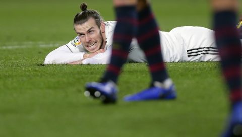 Real midfielder Gareth Bale lies on the pitch during the Copa del Rey semifinal first leg soccer match between FC Barcelona and Real Madrid at the Camp Nou stadium in Barcelona, Spain, Wednesday Feb. 6, 2019. (AP Photo/Manu Fernandez)