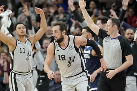 San Antonio Spurs' Marco Belinelli (18) runs upcourt after scoring a three-point basket as the team's bench and fans celebrate during the first half of an NBA basketball game against the Minnesota Timberwolves, Friday, Dec. 21, 2018, in San Antonio. (AP Photo/Darren Abate)