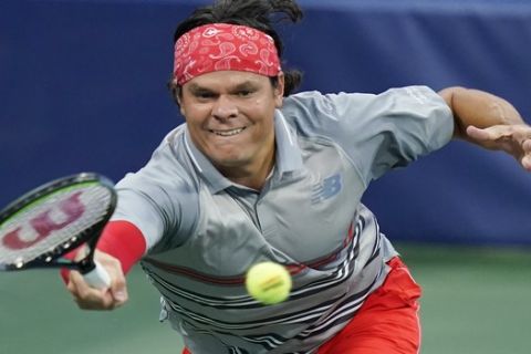 Milos Raonic, of Canada, returns a shot by Filip Krajinovic, of Serbia, during the quarterfinals at the Western & Southern Open tennis tournament Wednesday, Aug. 26, 2020, in New York. (AP Photo/Frank Franklin II)
