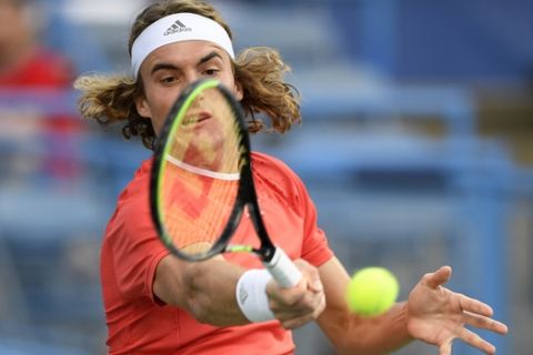 Stefanos Tsitsipas, of Greece, returns the ball during a match in the Citi Open tennis tournament against Benoit Paire, of France, Friday, Aug. 2, 2019, in Washington. (AP Photo/Nick Wass)