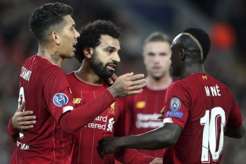 Liverpool's Mohamed Salah, second left, celebrates with teammates after scoring his side's third goal during the Champions League group E soccer match between Liverpool and Red Bull Salzburg at Anfield stadium in Liverpool, England, Wednesday, Oct. 2, 2019. (AP Photo/Jon Super)