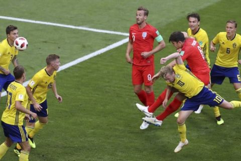 England's Harry Maguire, 4th right, heads the ball to score the opening goal during the quarterfinal match between Sweden and England at the 2018 soccer World Cup in the Samara Arena, in Samara, Russia, Saturday, July 7, 2018. (AP Photo/Thanassis Stavrakis)