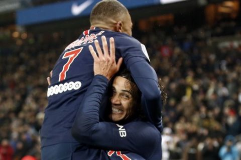 PSG's Kylian Mbappe celebrates with Edinson Cavani, right, after scoring his side's eighth goal during the League One soccer match between Paris Saint Germain and Guingamp at the Parc des Princes stadium in Paris, Saturday, Jan. 19, 2019. (AP Photo/Michel Euler)