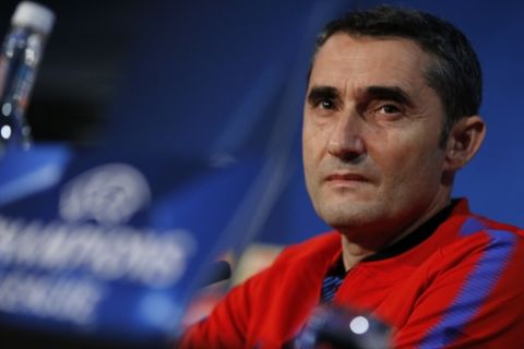 Barcelona coach Ernesto Valverde listens to journalists' questions during a news conference at Stamford Bridge stadium in London, Monday, Feb. 19, 2018. FC Barcelona will play Chelsea in a Champions League round of sixteen first leg soccer match on Tuesday. (AP Photo/Alastair Grant)