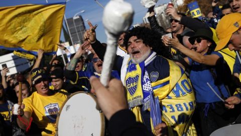 Boca Juniors supporters cheer ahead of the Copa Libertadores Final between River Plate and Boca Juniors in Madrid, Sunday, Dec. 9, 2018. Tens of thousands of Boca and River fans are in the city for the "superclasico" at Santiago Bernabeu Stadium on Sunday. (AP Photo/Emilio Morenatti)