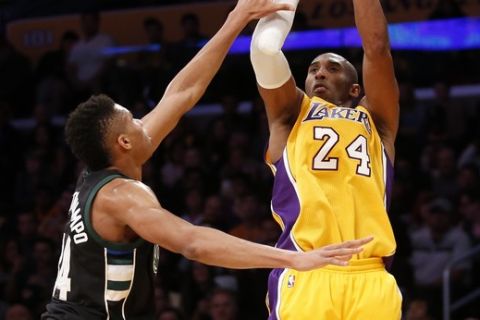 FILE - In this Tuesday, Dec. 15, 2015 file photo, Los Angeles Lakers' Kobe Bryant shoots as Milwaukee Bucks' Giannis Antetokounmpo defends during the second half of an NBA basketball game in Los Angeles. Bryant will be in his 16th Christmas game - his Lakers haven't had Dec. 25 off since 1998. (AP Photo/Danny Moloshok, File)