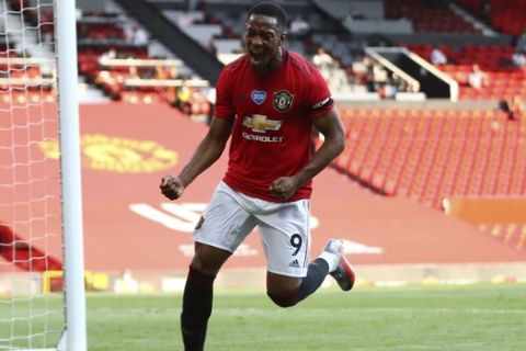Manchester United's Anthony Martial celebrates after scoring his side's third goal during the English Premier League soccer match between Manchester United and Sheffield United at Old Trafford in Manchester, England, Wednesday, June 24, 2020. (Michael Steele/Pool via AP)