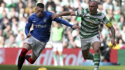 Rangers' Ryan Kent challenges with Celtic's Scott Brown, right, during their Scottish Premiership soccer match at Celtic Park in Glasgow, Scotland, Sunday March 31, 2019. (Andrew Milligan/PA via AP)