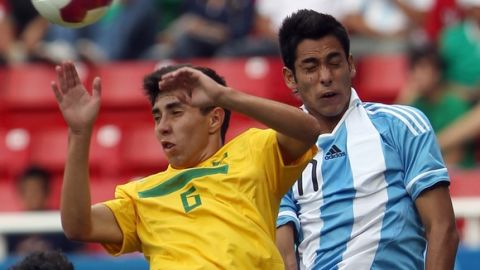 Brazil's Henrique Ribeiro (6) and Argentina's Sergio Araujo, right, go for a header during a men's soccer match at the Pan American Games in Guadalajara, Mexico, Wednesday, Oct. 19, 2011. (AP Photo/Juan Karita)