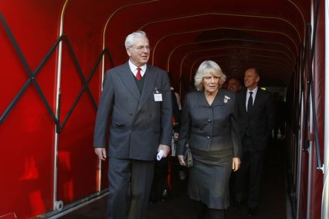 Britain's Camilla, Duchess of Cornwall  walks out of the tunnel with Sir Chips Keswick, Director of Arsenal Football Club at the Emirates Stadium in London, Thursday, Jan. 26, 2012. The Duchess of Cornwall, Patron of the National Literacy Trust launched the 2012 National Literacy Trust 'Premier League Reading Stars' at the stadium on Thursday. (AP Photo/Kirsty Wigglesworth, pool)