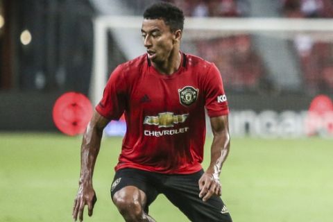 Manchester United's Jesse Lingard controls the ball during the International Champions Cup soccer match between Manchester United and Milan in Singapore, Saturday, July 20, 2019. (AP Photo/Danial Hakim)