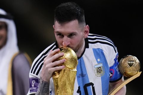 Argentina's Lionel Messi kisses the trophy after winning the World Cup final soccer match between Argentina and France at the Lusail Stadium in Lusail, Qatar, Sunday, Dec.18, 2022. (AP Photo/Manu Fernandez)