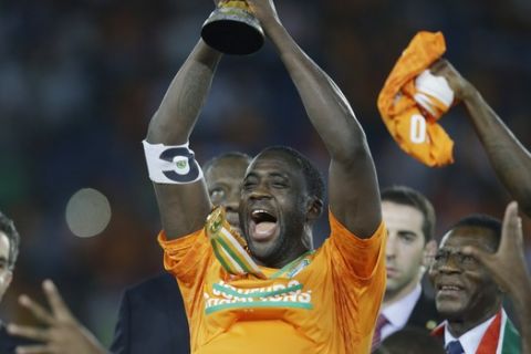 Ivory Coast's Yaya Toure, center, holds up the trophy after winning the African Cup of Nations final soccer match against Ghana in Bata, Equatorial Guinea, Sunday, Feb. 8, 2015. (AP Photo/Sunday Alamba)