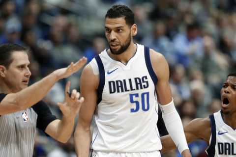 CORRECTS TO REFEREE DAVID GUTHRIE NOT BRIAN FORTE - Referee David Guthrie, left, charges Dallas Mavericks center Salah Mejri (50), of Tunisia, with a technical foul as Dennis Smith Jr. (1) watches in the second half of an NBA basketball game against the Washington Wizards on Monday, Jan. 22, 2018, in Dallas. Moments later Mejri was charged with a second technical and ejected from the game. (AP Photo/Tony Gutierrez)