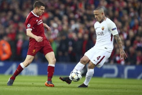 Liverpool's James Milner, left, vies for the ball with Roma's Radja Nainggolan during the Champions League semifinal, first leg, soccer match between Liverpool and AS Roma at Anfield Stadium, Liverpool, England, Tuesday, April 24, 2018. (AP Photo/Dave Thompson)