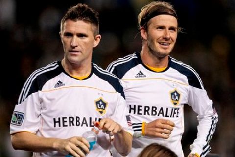 Los Angeles Galaxy midfielder David Beckham, right, stands with teammate Robbie Keane after the Galaxy defeated Real Salt Lake during their MLS Western Conference Championship soccer match, Sunday, Nov. 6, 2011, in Carson, Calif. The Galaxy won 3-1. (AP Photo/Bret Hartman)