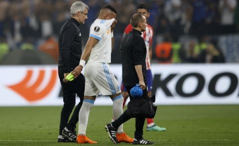 Marseille's Dimitri Payet walks off the pitch after sustaining an injury during the Europa League Final soccer match between Marseille and Atletico Madrid at the Stade de Lyon in Decines, outside Lyon, France, Wednesday, May 16, 2018. (AP Photo/Francois Mori)