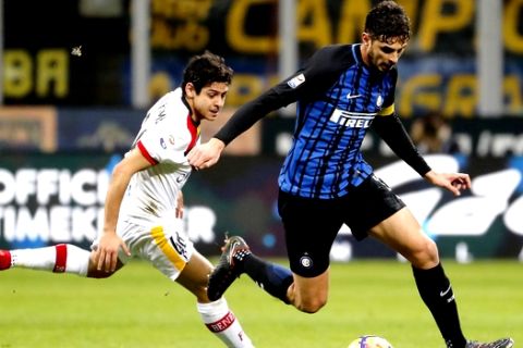 Inter Milan's Andrea Ranocchia, right, challenges for the ball with Benevento's Marquees Guilherme Costa during the Serie A soccer match between Inter Milan and Benevento at the San Siro stadium in Milan, Italy, Saturday, Feb. 24, 2018. (AP Photo/Antonio Calanni)