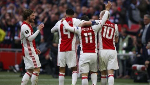 Ajax's Amin Younes (11) celebrates with his teammates after scoring the third goal of his team during the first leg semi final soccer match between Ajax and Olympique Lyon in the Amsterdam ArenA stadium, Netherlands, Wednesday, May 3, 2017. (AP Photo/Peter Dejong)