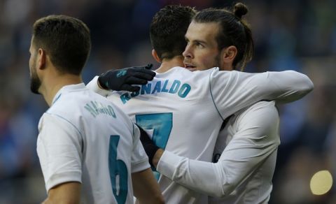 Real Madrid's Gareth Bale, right, celebrates with teammate Cristiano Ronaldo after scoring his side's third goal against Deportivo Coruna during a Spanish La Liga soccer match between Real Madrid and Deportivo Coruna at the Santiago Bernabeu stadium in Madrid, Sunday, Jan. 21, 2018. (AP Photo/Francisco Seco)