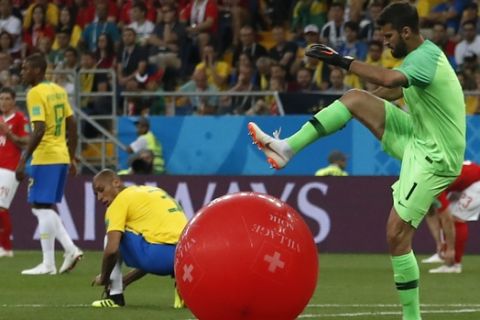 Brazil goalkeeper Alisson, right, kicks a balloon during the group E match between Brazil and Switzerland at the 2018 soccer World Cup in the Rostov Arena in Rostov-on-Don, Russia, Sunday, June 17, 2018. (AP Photo/Darko Vojinovic)