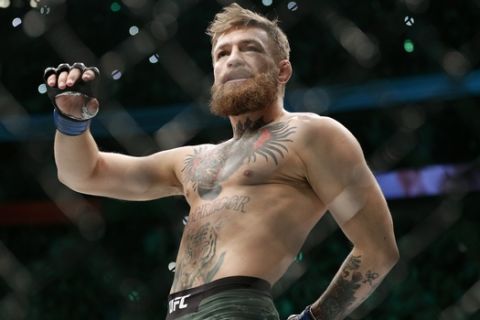 FILE - In this Oct. 6, 2018, file photo, Conor McGregor walks in the cage before fighting Khabib Nurmagomedov in a lightweight title mixed martial arts bout at UFC 229 in Las Vegas.  Superstar UFC fighter McGregor has announced on social media that he is retiring from mixed martial arts. McGregors verified Twitter account had a post early Tuesday, March 26, 2019,  that said the former featherweight and lightweight UFC champion was making a quick announcement. (AP Photo/John Locher, File)