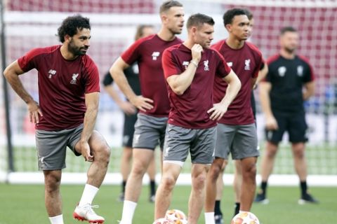 Liverpool forward Mohamed Salah, left, stands with James Milner during a training session at the Wanda Metropolitano stadium in Madrid, Friday May 31, 2019. English Premier League teams Liverpool and Tottenham Hotspur are preparing for the Champions League final which takes place in Madrid on Saturday night. (AP Photo/Manu Fernandez)