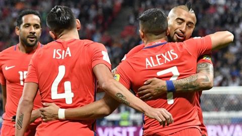Chile's Alexis Sanchez, second from right, is hugged by his teammate Arturo Vidal after scoring the opening goal during the Confederations Cup, Group B soccer match between Germany and Chile, at the Kazan Arena, Russia, Thursday, June 22, 2017. (AP Photo/Martin Meissner)