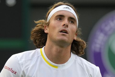 Greece's Stefanos Tsitsipas reacts after losing a point to Switzerland's Alexander Ritschard during their singles tennis match on day two of the Wimbledon tennis championships in London, Tuesday, June 28, 2022. (AP Photo/Alastair Grant)