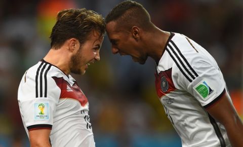 RIO DE JANEIRO, BRAZIL - JULY 13:  Mario Goetze of Germany (L) celebrates scoring his team's first goal with Jerome Boateng during the 2014 FIFA World Cup Brazil Final match between Germany and Argentina at Maracana on July 13, 2014 in Rio de Janeiro, Brazil.  (Photo by Matthias Hangst/Getty Images)