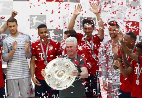 Bayern's head coach Jupp Heynckes, center, lifts the trophy after the German Soccer Bundesliga match between FC Bayern Munich and VfB Stuttgart in Munich, Germany, Saturday, May 12, 2018. (AP Photo/Matthias Schrader)