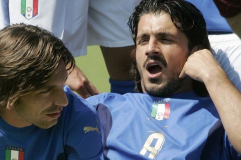Italy's soccer team midfielder Gennaro Gattuso, right, and Andrea Pirlo relax as they pose for the official photo wearing the new jerseys designed by Dolce & Gabbana, prior to a practice session at the Coverciano training grounds, near Florence, Italy, Thursday May 25, 2006 in view of the forthcoming World Cup 2006 in Germany. Italy will play in Group E with USA, Czech Republic and Ghana. (AP Photo/Lorenzo Galassi)