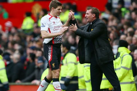 Football - Manchester United v Liverpool - Barclays Premier League - Old Trafford - 16/3/14
Liverpool's Steven Gerrard celebrates with manager Brendan Rodgers (R)
Mandatory Credit: Action Images / Jason Cairnduff
Livepic
EDITORIAL USE ONLY. No use with unauthorized audio, video, data, fixture lists, club/league logos or "live" services. Online in-match use limited to 45 images, no video emulation. No use in betting, games or single club/league/player publications.  Please contact your account representative for further details.