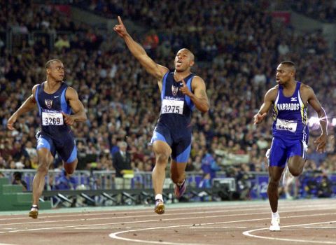 ** FILE ** Maurice Greene of the United States celebrates as he crosses the finish line after winning the men's 100 meters at Olympic Park during the 2000 Summer Olympics in Sydney, in this Saturday, Sept. 23, 2000 file photo.  At left is Jonathan Drummond of the United States and at right is Obadele Thompson of Barbados. Greene announced his retirement Monday Feb. 4, 2008, citing nagging injuries for his decision. (AP Photo/Doug Mills, File)