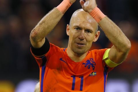 Netherland's Arjen Robben, left, greets supporters as he leaves the pitch flanked by his sons at the end of the World Cup Group A soccer qualifying match between the Netherlands and Sweden at the ArenA stadium in Amsterdam, Netherlands, Tuesday, Oct. 10, 2017. To add to the Dutch disappointment who failed to qualify for the 2018 World Cup tournament, star winger Arjen Robben announced his retirement from international football after the game. (AP Photo/Peter Dejong)