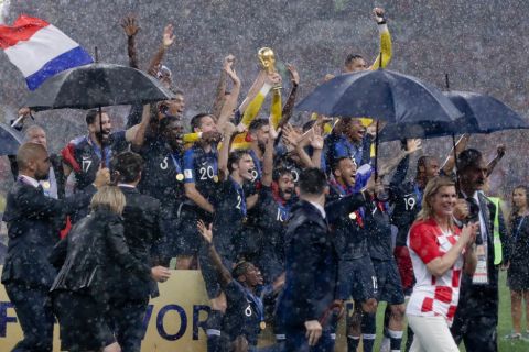 France players hold up the World Cup trophy at the end of the final match between France and Croatia at the 2018 soccer World Cup in the Luzhniki Stadium in Moscow, Russia, Sunday, July 15, 2018. France won 4-2. (AP Photo/Petr David Josek)