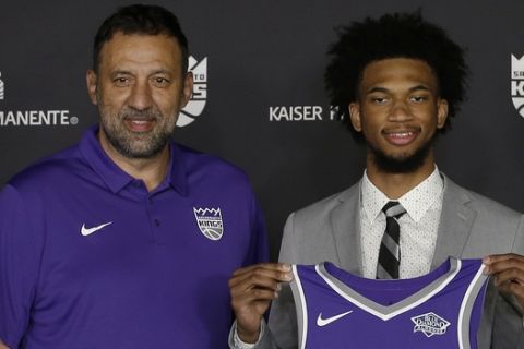 Marvin Bagley III, center, holds up a Sacramento Kings basketball jersey as he poses with Sacramento Kings general manager Vlade Divac, left, and Kings head coach David Joerger, during a news conference, Saturday, June 23, 2018. Bagley III, a freshmen forward from Duke, is the Kings first draft pick, the second overall, in Thursday's NBA basket ball draft. (AP Photo/Rich Pedroncelli)