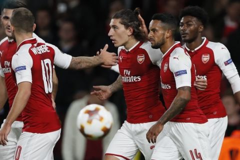 Arsenal's Hector Bellerin, center, celebrates with teammates after scoring during the Europa League group H soccer match between Arsenal and FC Cologne at the Emirates stadium in London, England, Thursday, Sept. 14, 2017 . (AP Photo/Kirsty Wigglesworth)