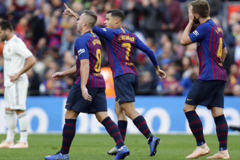 Barcelona forward Philippe Coutinho, second right, celebrates scoring his side's opening goal with his teammates during the Spanish La Liga soccer match between FC Barcelona and Real Madrid at the Camp Nou stadium in Barcelona, Spain, Sunday, Oct. 28, 2018. (AP Photo/Manu Fernandez)